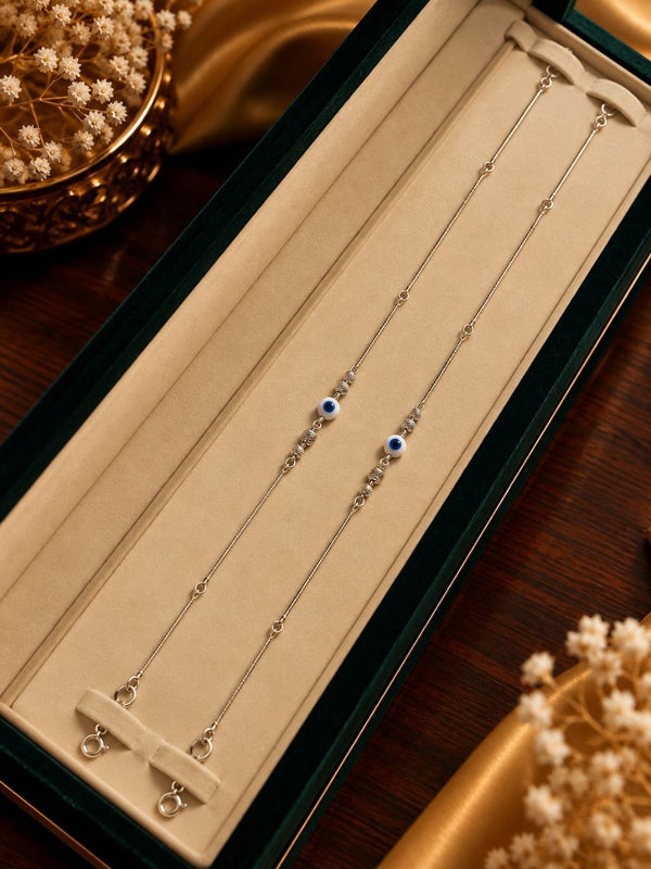 Aura Azure Evil Eye Silver Anklet Pair - Luxury Velvet Presentation Box Pair Display - SURIYAS Jewel Studio - Angle & Detail View | SURIYAS